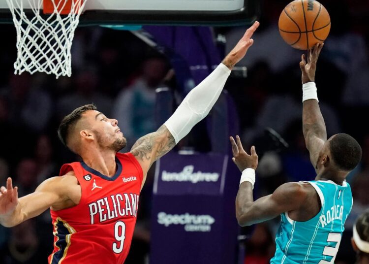 New Orleans Pelicans Willy Hernangomez (L) defends on a shot by Charlotte Hornets Terry Rozier during their NBA game in Charlotte.