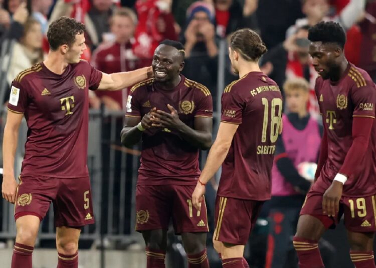 Bayern Munich players celebrate after scoring during their Bundesliga match against Bayer 04 Leverkusen in Munich.