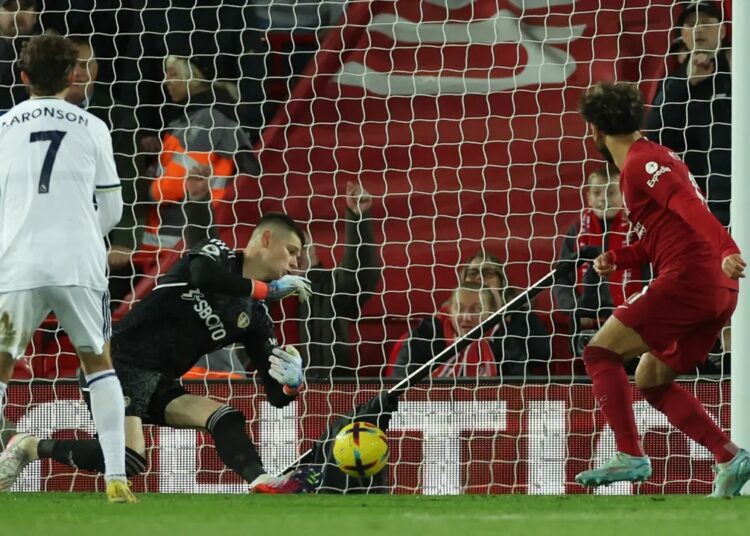 Liverpool’s Mohamed Salah (R) scores his side’s sole goal against Leeds United.
