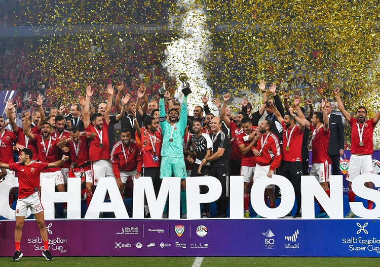 Al-Ahly players celebrate with the trophy of the Egyptian Super Cup after winning over Zamalek at the Hazza Bin Zayed Stadium in Al-Ain.