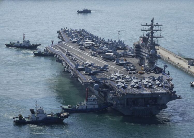 FILE - The US carrier USS Ronald Reagan is escorted as it arrives in Busan, South Korea on Sept. 23, 2022.