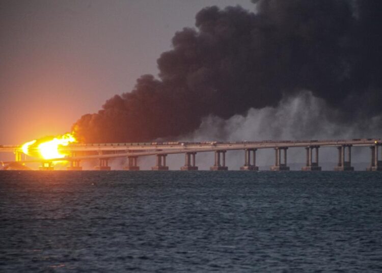 Flame and smoke rise from the Crimean Bridge connecting Russian mainland and the Crimean peninsula over the Kerch Strait, in Kerch, Crimea, October 8, 2022.