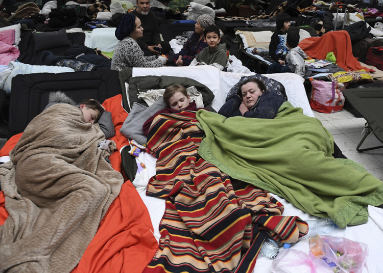 Poland receives 6.999 mln refugees from Ukraine 1 - Egyptian Gazette A file photo shows people sleep on cots, at a reception center for displaced persons from Ukraine, at the Ukrainian-Polish border crossing in Korczowa, Poland on March 5, 2022.