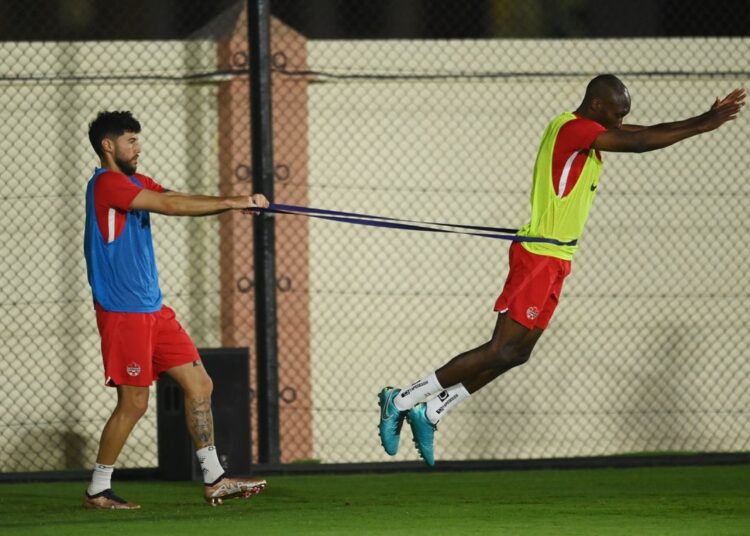 Canada's Jonathan Osorio and Atiba Hutchinson during training session in readiness for Belgium match on Wednesday.