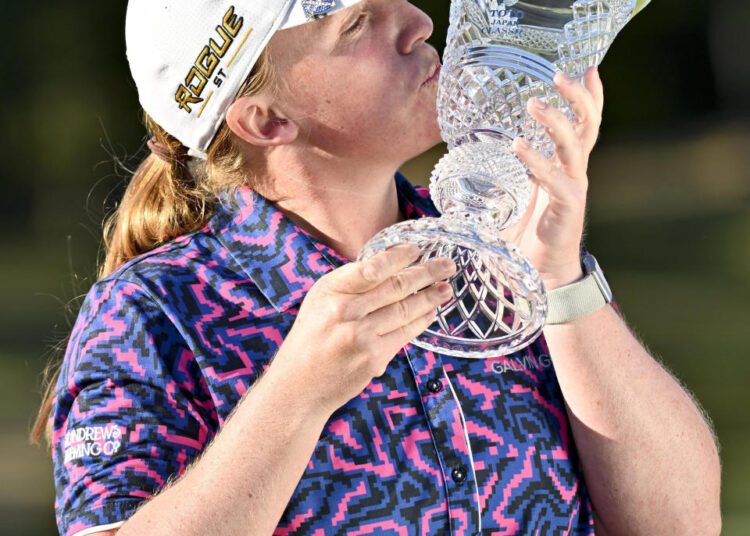 Gemma Dryburgh kisses the trophy after winning the LPGA Tour's Japan Classic in Shiga, Japan.