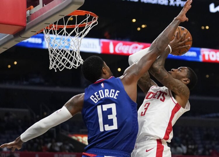 LA Clippers Paul George (L) defends against Houston Rockets Kevin Porter Jr. during the second half of an NBA game in Los Angeles.