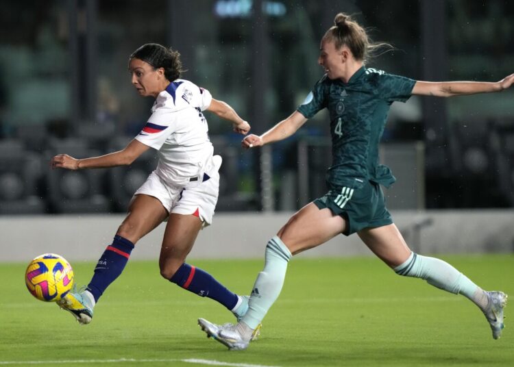 US Mallory Pugh (L) attempts a shot on the goal as Germany defender Sophia Kleinherne defends during their international friendly soccer match.
