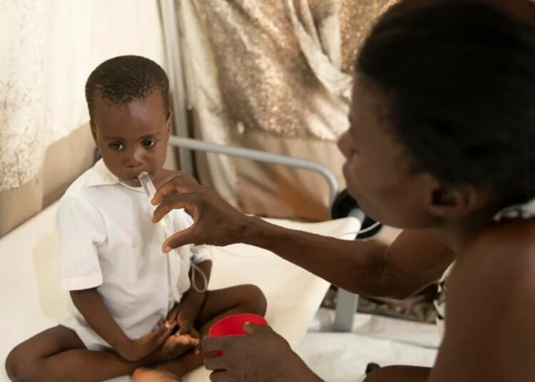 A mother hydrates her son who is stricken with cholera, at a clinic run by Doctors Without Borders in Port-au-Prince, Haiti, Friday, Nov. 11, 2022.