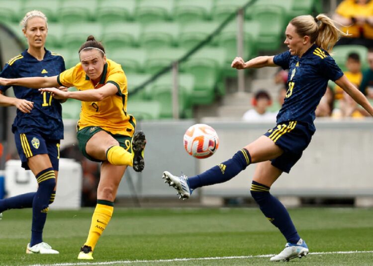 Australia’s forward Caitlin Foord (C) scores against Sweden during their women's friendly soccer match in Melbourne.