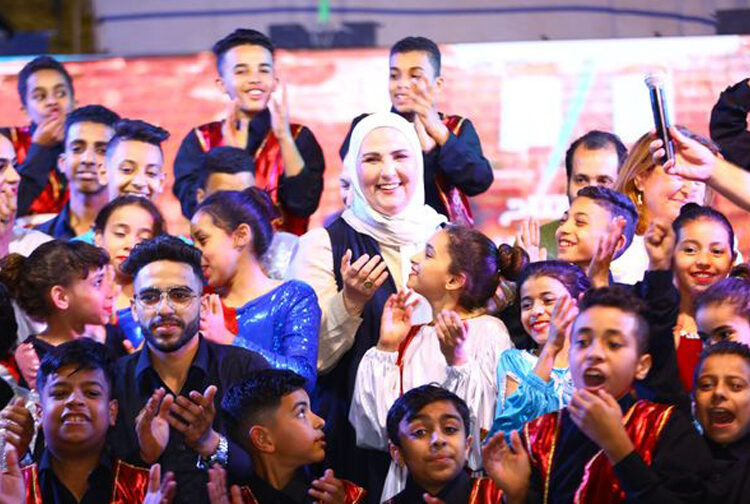 Social Solidarity Minister Nevine el-Qabbag surrounded by a group of children during one of the many ministry's events aiming to promote their conditions.