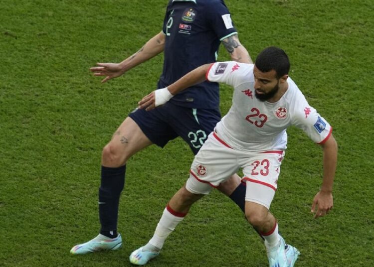 Tunisia’s Naim Sliti (R) challenges with Australia’s Jackson Irvine during their group D match on Nov. 26, 2022.