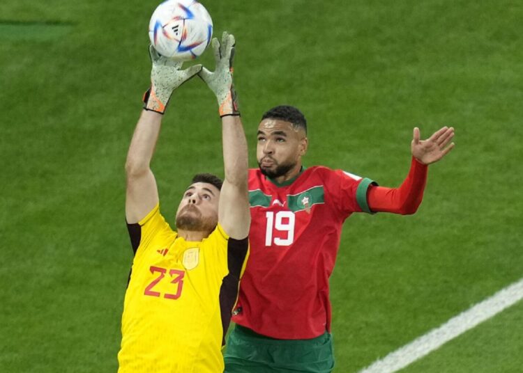 Spain’s goalkeeper Unai Simon catches the ball in front Morocco’s Youssef En-Nesyri during the World Cup round of 16 match on Dec. 6, 2022.