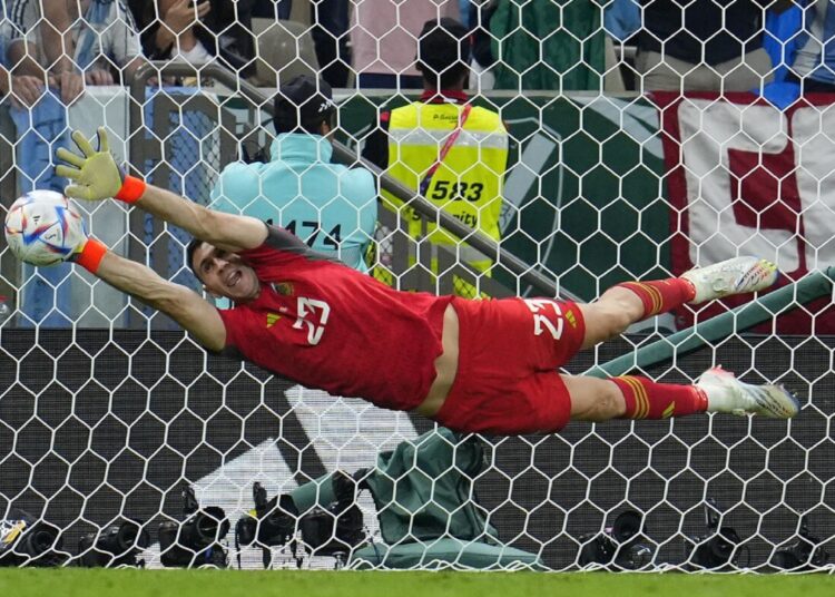 Argentina's goalkeeper Emiliano Martinez saves a kick during penalty shootout against the Netherlands at a World Cup quarter-final match.