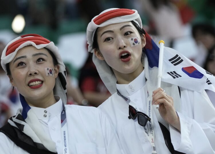 Fans cheer before the World Cup group H match between South Korea and Portugal, at the Education City Stadium in Al Rayyan.