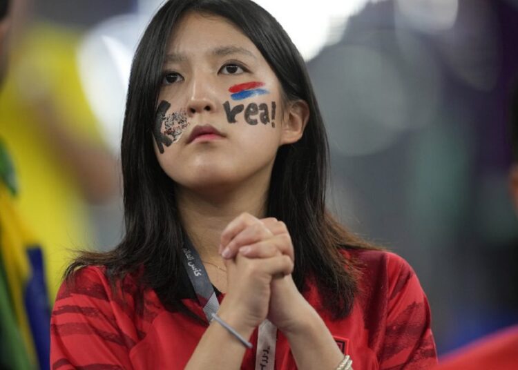 Brazil stuns S. Korea to set quarters clash with Croatia 1 - Egyptian Gazette A South Korea fan waits for the start of the World Cup round of 16 match between Brazil and South Korea.
