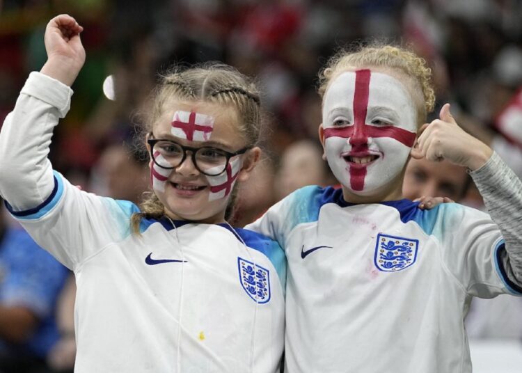 Two young supporters cheer for England before the round of 16 match between England and Senegal on Dec. 4, 2022.