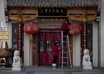 China reduces Covid-19 case number reporting as virus surges