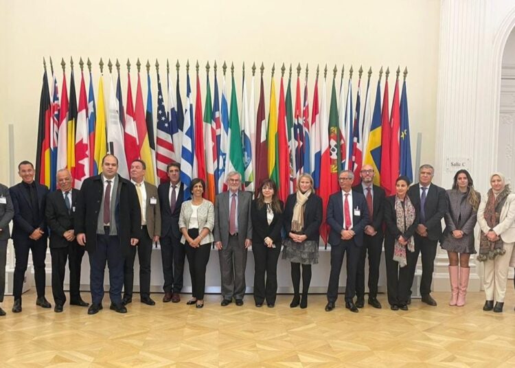 Mahmoud Momtaz, head of the Egyptian Competition Authority, in a group photo with high-level officials from more than 100 competition authorities worldwide, following taking part in 2022 Global Forum on Competition in Paris.