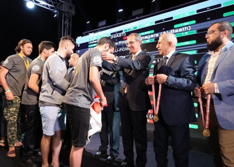 Minister of Communications and Information Technology Amr Talaat honoring the top winners in 25th Arab and African Software Competition for university students.