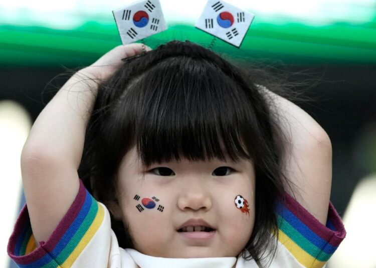 A little girl waits for the start of the World Cup group H match between South Korea and Portugal.