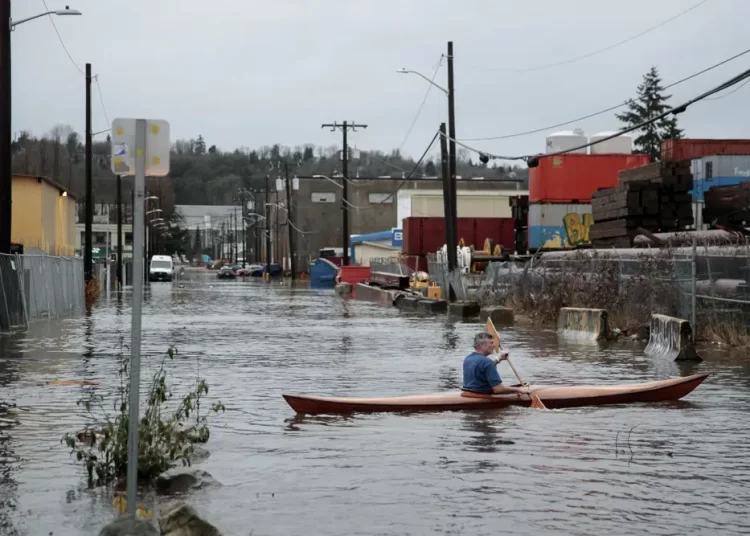 A person kayaks on South Portland Street in Seattle's South Park neighbourhood Tuesday morning, December 27, 2022