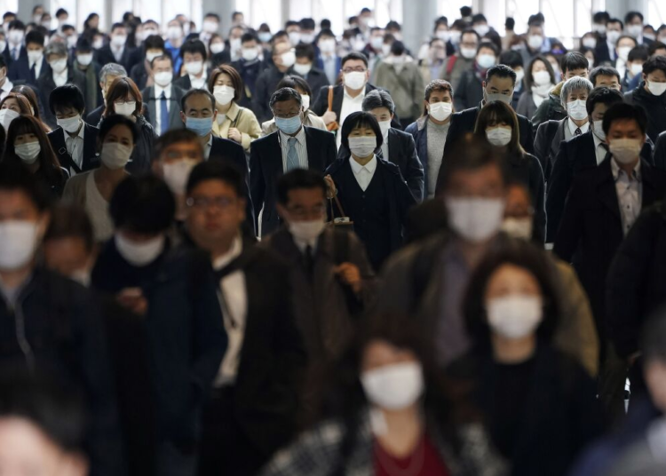 A station passageway is crowded with commuters in Tokyo, April 27, 2020.