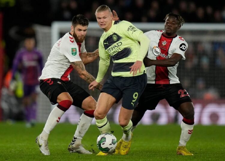 Manchester City's Erling Haaland (C) battles for the ball with Southampton defenders during the English League Cup quarter-final match on January 11, 2023.