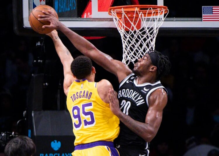 Brooklyn Nets Day'Ron Sharpe (R) blocks a shot by Los Angeles Lakers Juan Toscano-Anderson during an NBA game in New York.