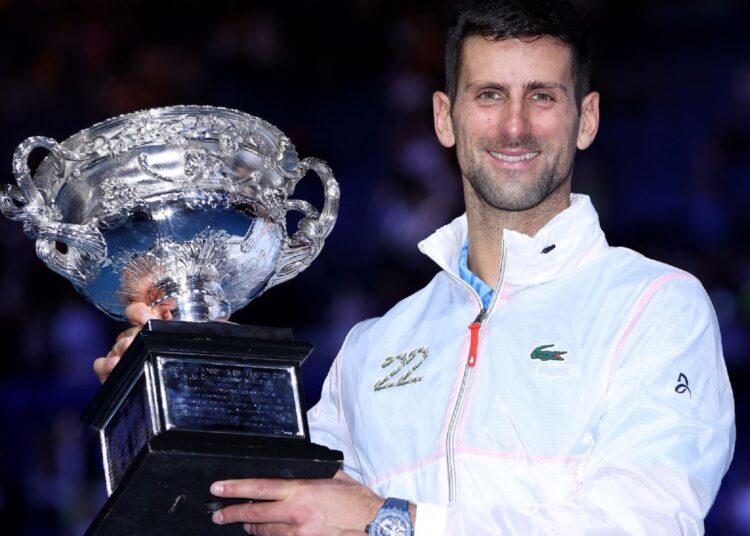 Novak Djokovic poses with the trophy, as he claimed his 22nd Grand Slam title.
