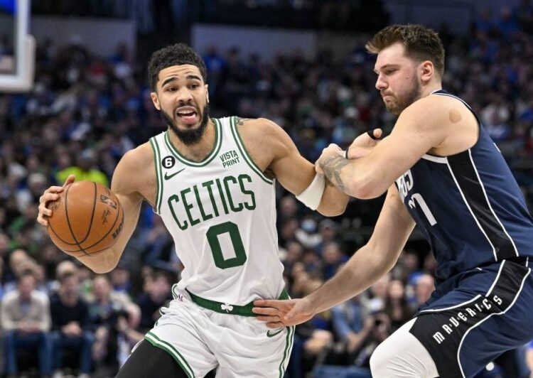 Boston Celtics Jayson Tatum (0) looks to move the ball past Dallas Mavericks Luka Doncic (77) during the second quarter at the American Airlines Center.