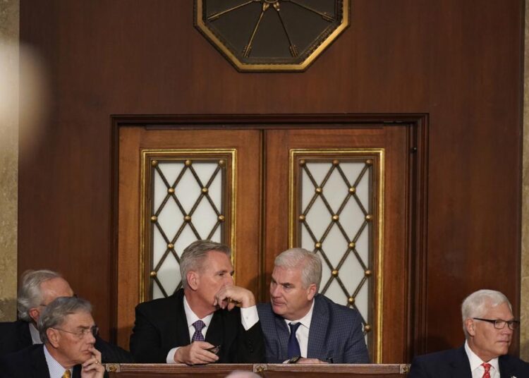 Rep. Kevin McCarthy, R-Calif., talks to Rep. Tom Emmer, R-Minn., during a sixth round of voting in the House chamber as the House meets for a second day to elect a speaker and convene the 118th Congress in Washington, Wednesday, January 4, 2023.