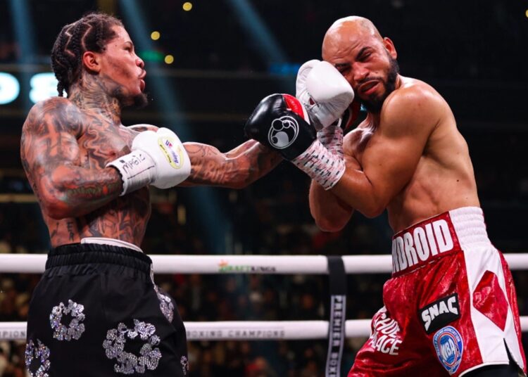 Gervonta Davis (L) delivers a shot to the head of Luis Garcia during their boxing match for the WBA lightweight title in Washington.