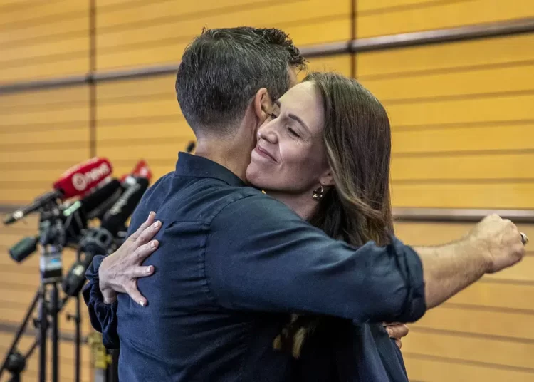 New Zealand Prime Minister Jacinda Arden, (R) hugging her fiancée  Clark Gayford after announcing her resignation at a press conference in Napier, New Zealand, on Thursday, January 19, 2023.