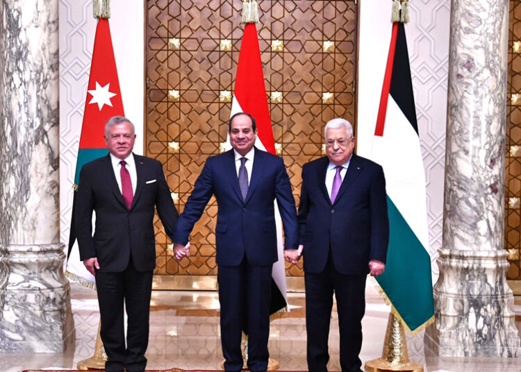 President Abdel Fattah El Sisi holding hands with King Abdullah II of Jordan and Palestinian President Mahmoud Abbas during a tripartite summit on Palestine, held in Cairo on Tuesday.