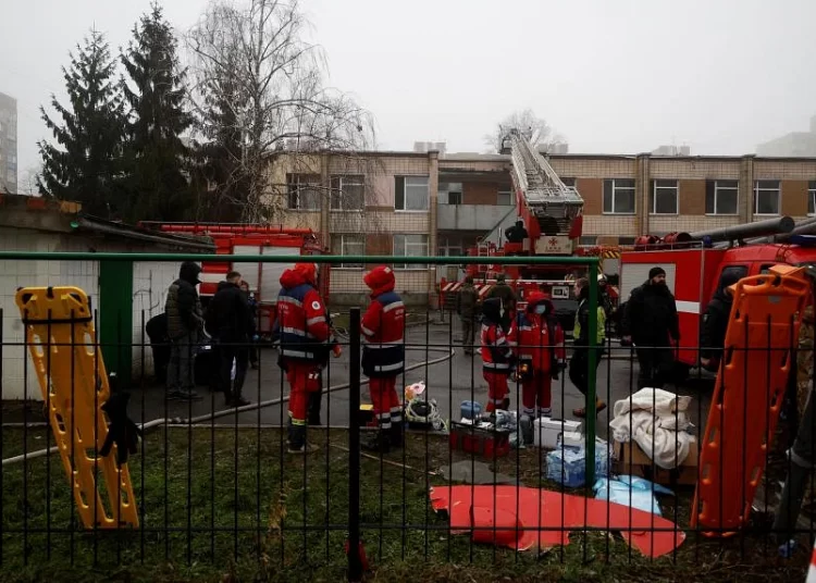 Emergency personnel working at the site where a helicopter crashed, in Brovary, outside Kyiv, on January 18, 2023.