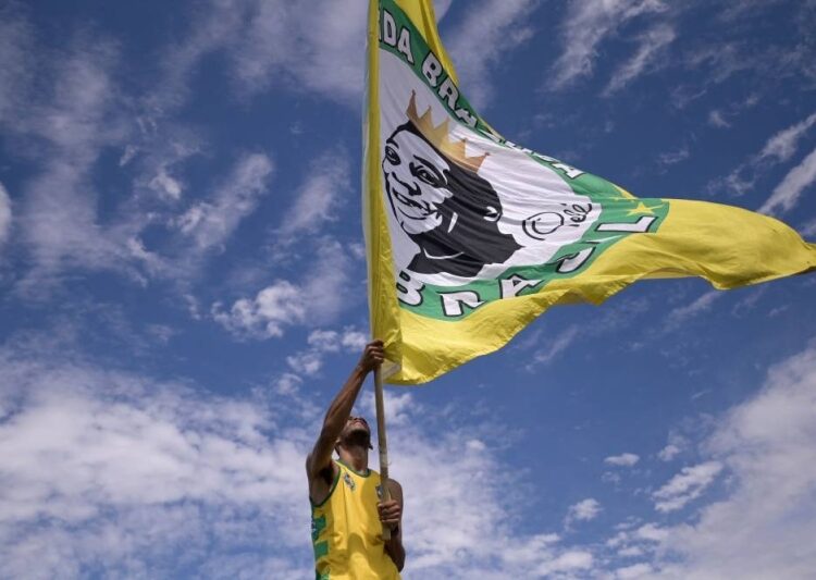 Final farewell for Pele, Brazil’s football ‘King’ 1 - Egyptian Gazette A fan pays homage to Pele in front of a replica of the house where he was born and which was built according to the memories of his mother, Celeste Arantes, in Tres Coracoes, state of Minas Gerais, Brazil, on December 30, 2022.