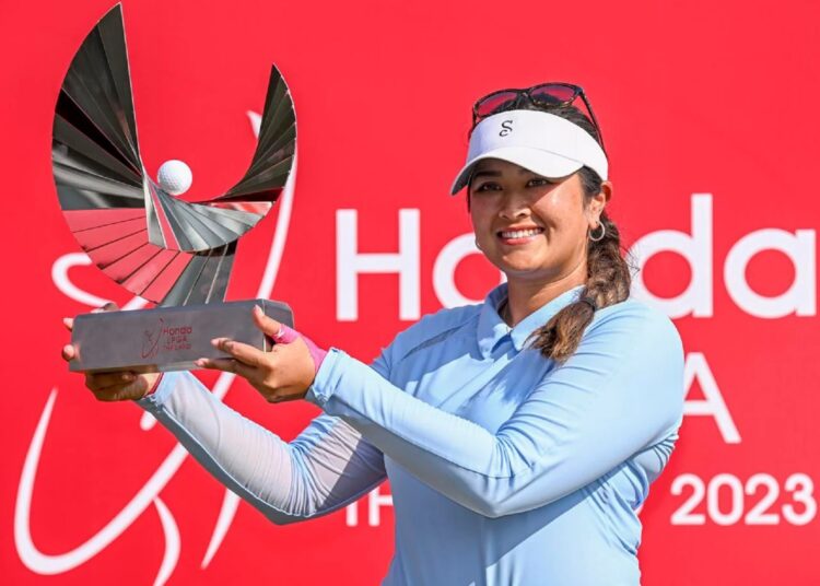 Lilia Vu poses with her trophy after winning the LPGA Honda Thailand golf tournament in Pattaya, southern Thailand.