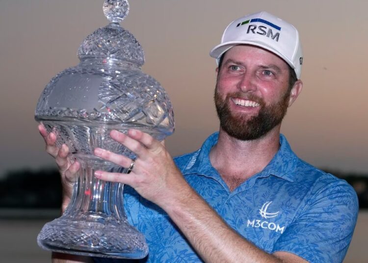 Chris Kirk poses with her trophy after winning the Honda Classic golf tournament in Florida.