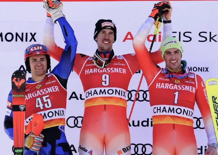Switzerland's Ramon Zenhaeusern (C) winner of an alpine ski, men's World Cup slalom, celebrates on the podium with second-placed Greece's Aj Ginnis (L) and third-placed Switzerland's Daniel Yule, in Chamonix, France.