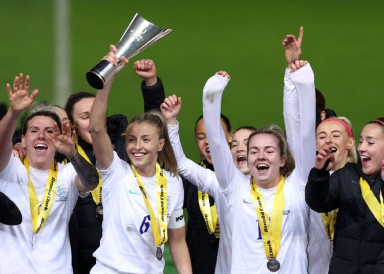 England's Leah Williamson lifts the trophy with teammates after winning the Arnold Clark Cup.