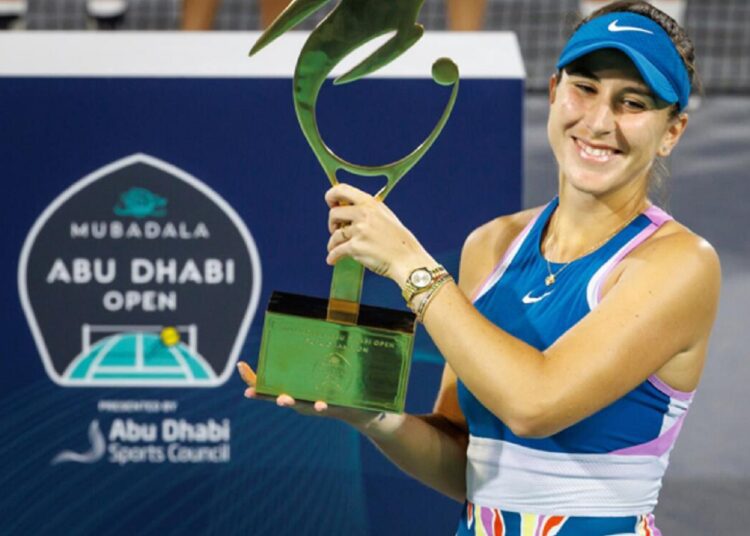 Belinda Bencic of Switzerland poses with the Abu Dhabi Open trophy.