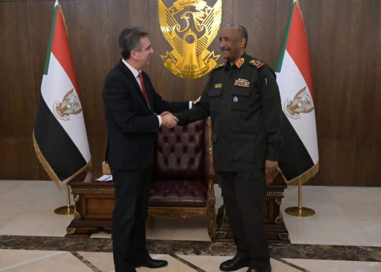 Israeli Foreign Minister Eli Cohen (L) meets with Sudanese ruler Gen. Abdel Fattah al-Burhan in Khartoum on February 2, 2023.