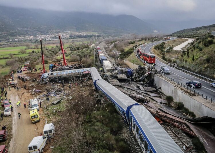 Police and emergency crews, pictured on March 1, 2023 search the debris of a crushed wagon after a deadly train collision in central Greece on Tuesday.