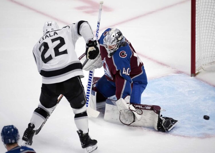 Los Angeles Kings Kevin Fiala (L) has his shot deflected by Colorado Avalanche goaltender Alexandar Georgiev during NHL game in Denver.
