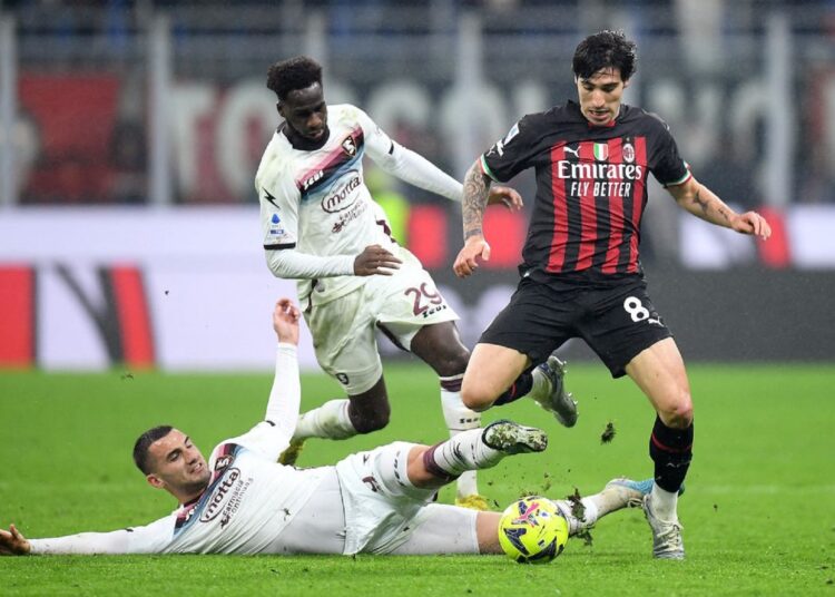 AC Milan’s Sandro Tonali (R) in action with Salernitana’s Boulaye Dia (C) and Federico Bonazzoli.