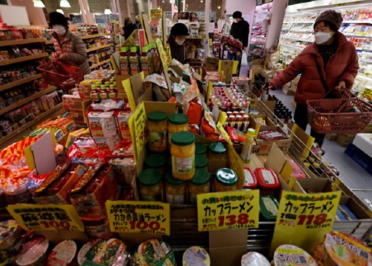 Shoppers check food items at a supermarket in Tokyo, Japan January 20, 2023.