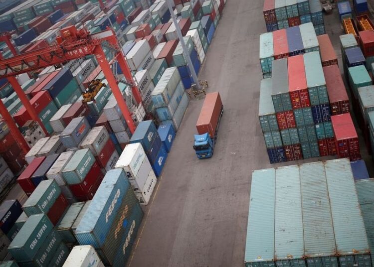 South Korea industrial output slumps 1 - Egyptian Gazette A truck drives between shipping containers at a container terminal at Incheon port in Incheon, South Korea.