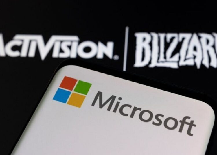 Microsoft logo is seen on a smartphone placed on displayed Activision Blizzard logo in this illustration taken January 18, 2022.