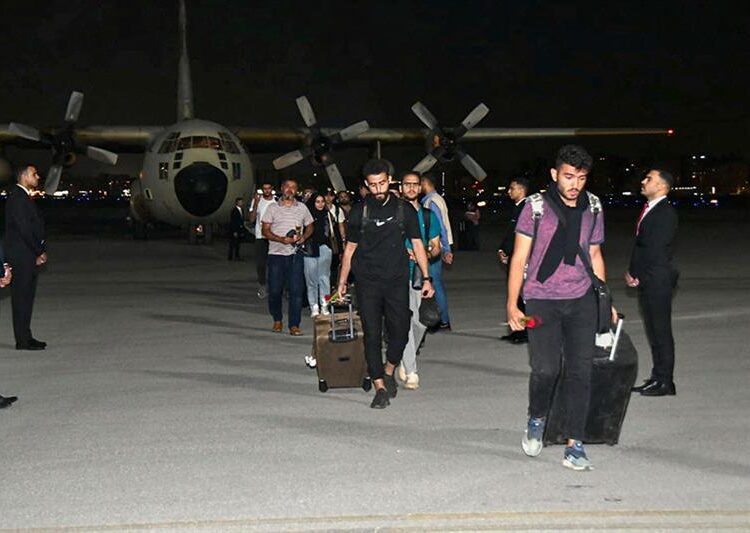Egyptian evacuees from Sudan disembarking upon landing in Cairo on April 24, 2023. AFP