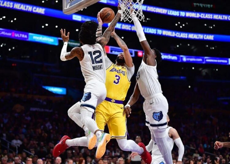 LeBron leads Lakers past Grizz 117-111 1 - Egyptian Gazette Los Angeles Lakers Anthony Davis (C) moves to the basket against Memphis Grizzlies Ja Morant (L) and Jaren Jackson Jr. during the first-half in Game 5 of the 2023 NBA playoffs.